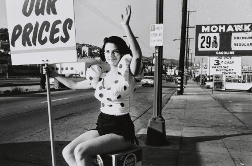 Bruce Davidson, Girl Waving with Sign on Road (Los Angeles series), 1964. (Courtesy: The Phillips Collection)